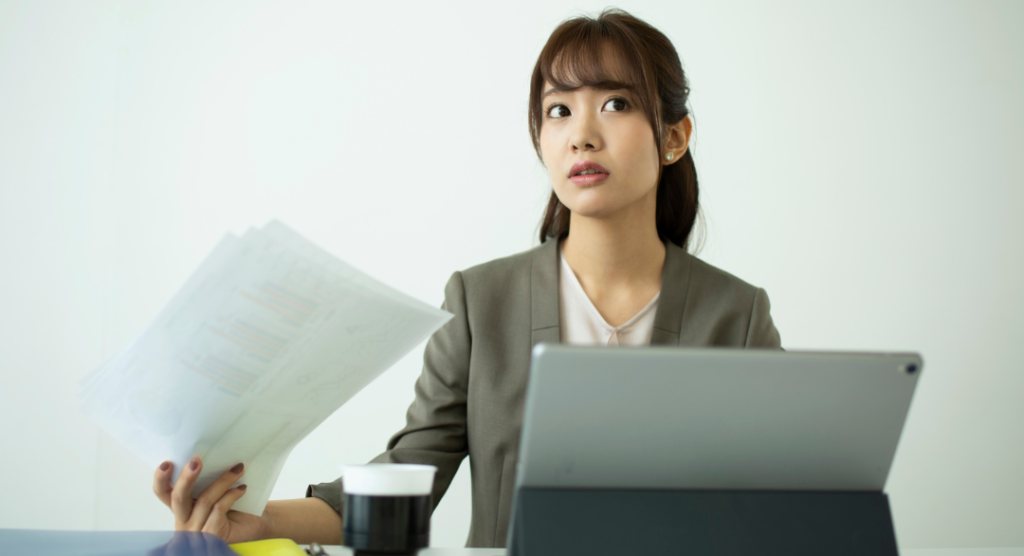 Mental health practice owner reviewing prior authorization behavioral health tracking and appeal status on laptop at desk
