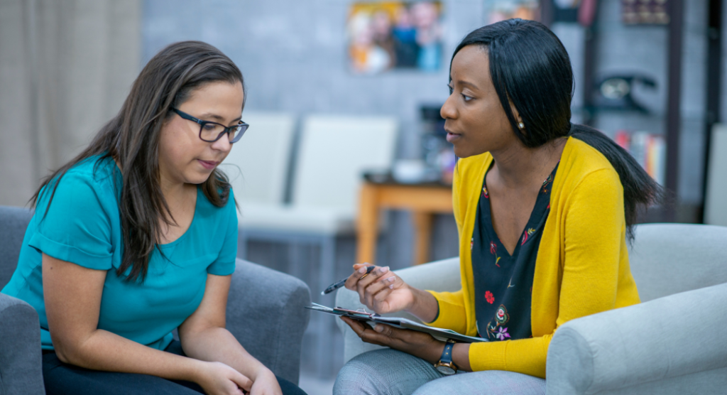 Human connection in behavioral health care — therapist listening actively to patient in session